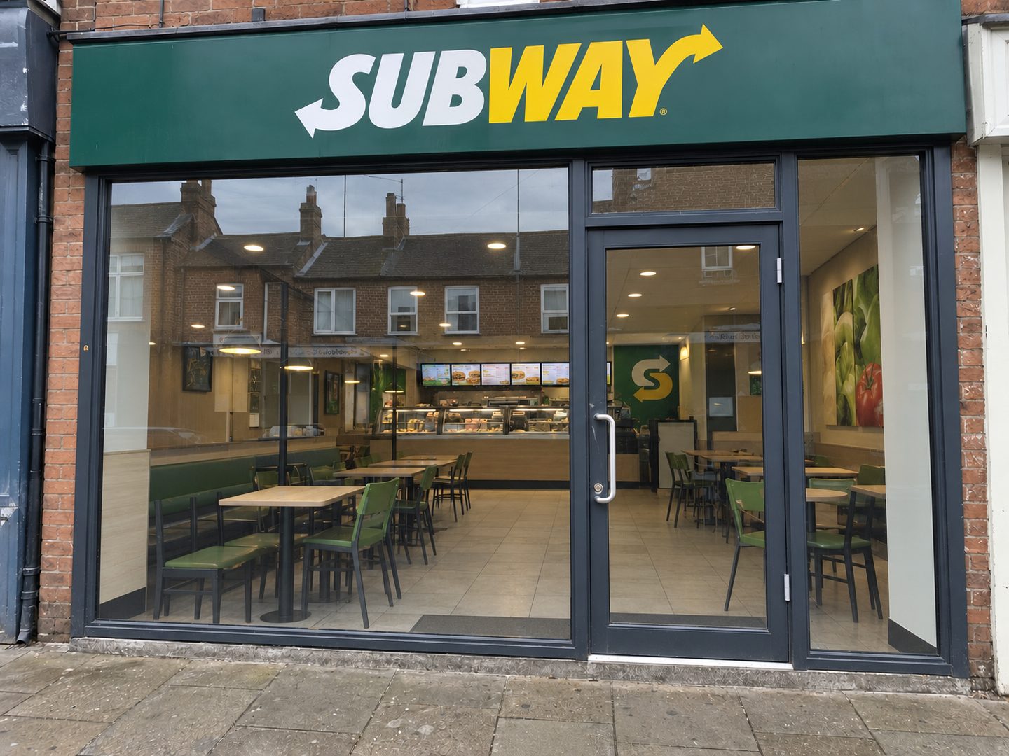 The same shopfront after cleaning, glass and frames clear through to the counter