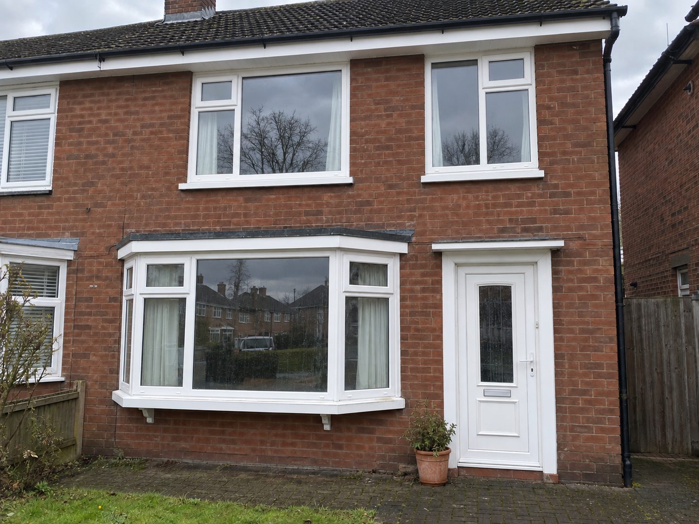 Bay-fronted semi after cleaning, the uPVC frames, sills and bay roof back to white